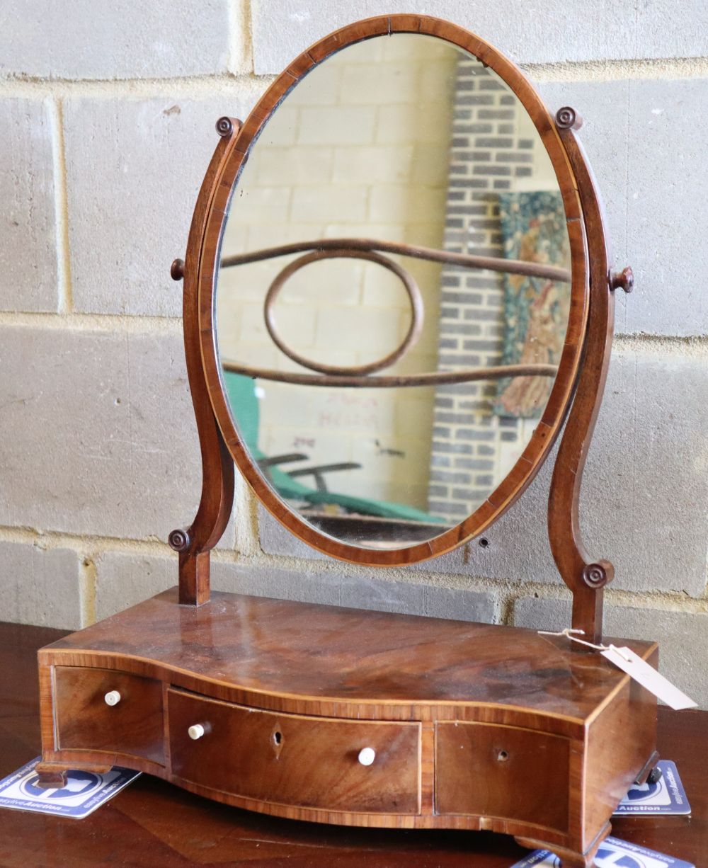 A George III mahogany and boxwood strung swing-frame toilet mirror, W.43cm, D.21cm, H.56cm